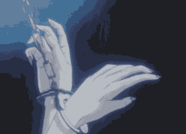 a close up of a person 's hands tied up with a chain