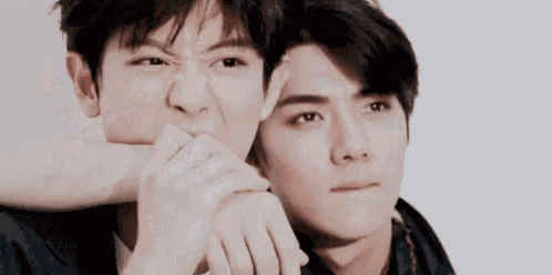 a close up of two men making funny faces while standing next to each other .