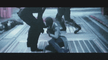 a group of people are fighting in a room