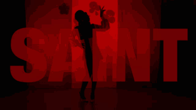 a silhouette of a woman in front of the word saint in red