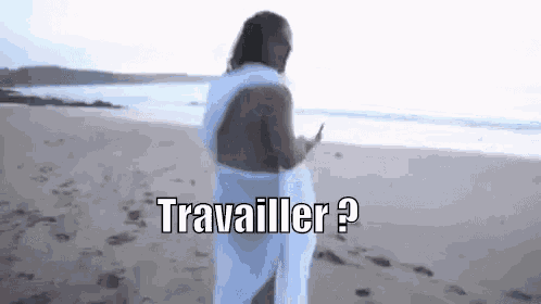 a naked man is standing on a beach with a towel around his waist and the words travailler written on the bottom .