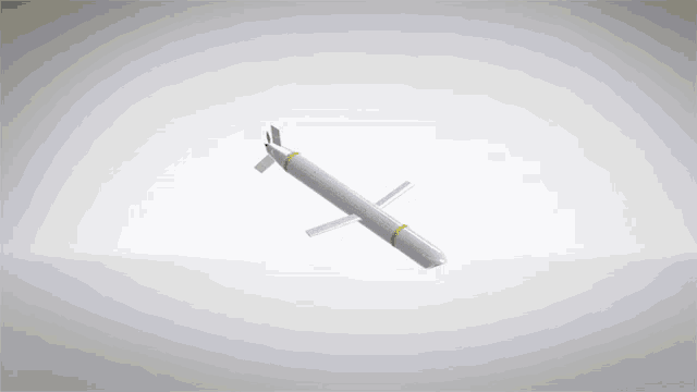 a white missile with a yellow stripe on the bottom is flying in the air