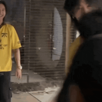 a man wearing a yellow shirt that says " one of us "