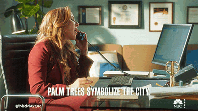 a woman sitting at a desk talking on a phone with the words palm trees symbolize the city written below her