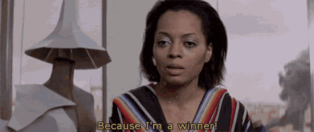 a woman says " because i 'm a winner " in front of a lamp