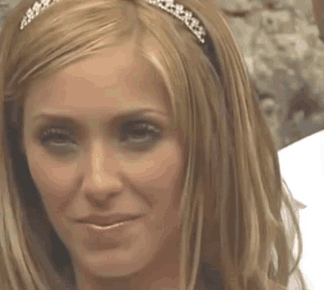 a close up of a woman 's face with a headband on her head