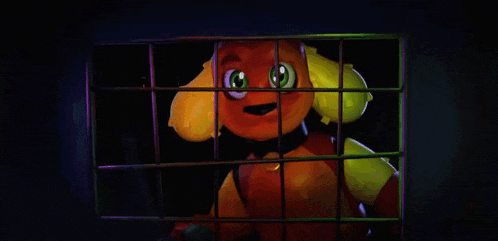 a stuffed animal with green eyes is behind bars in a dark room