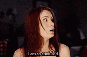 a woman with long red hair is making a funny face and saying i am so confused .