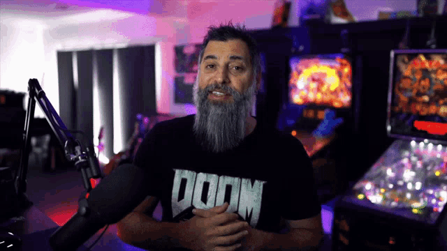 a man with a beard is wearing a black shirt that says doom