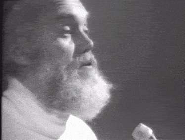 a black and white photo of a man with a beard