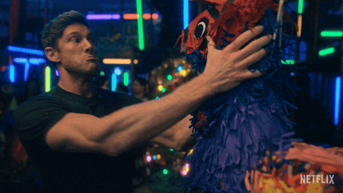 a man holding a piñata with a netflix logo on the bottom right
