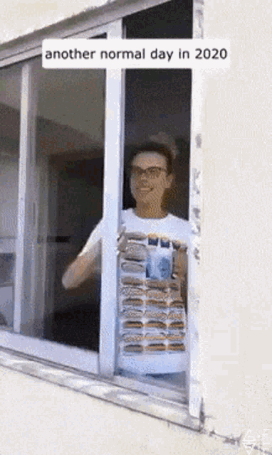 a man holding a stack of hamburgers in front of a window that says another normal day in 2020 on it