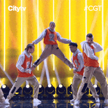 a group of men are performing a dance on a stage with the city tv logo in the background