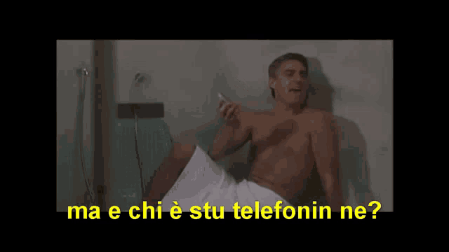 a shirtless man in a white towel is talking on a cell phone and the caption says ma e chi e stu telefonin ne