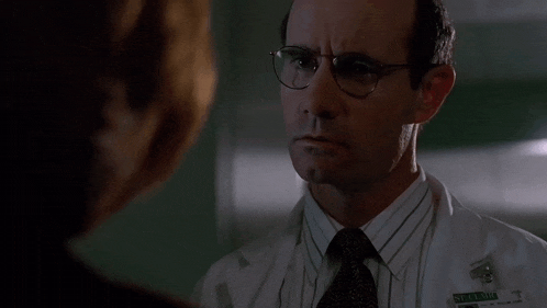 a man with glasses and a name tag that says " i don t know "