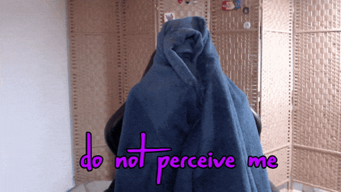 a person covered in a blue blanket with the words do not perceive me above them