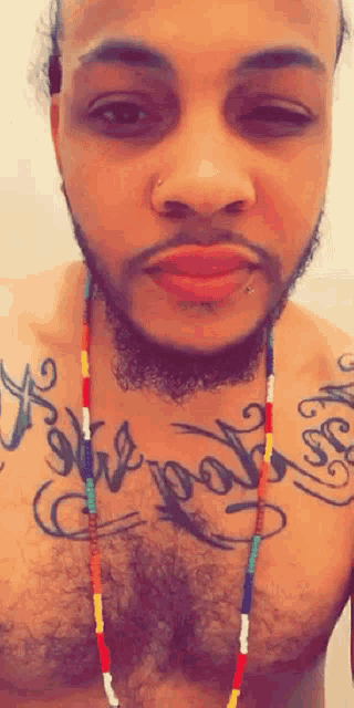 a man has a tattoo on his chest that says for god