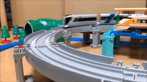 a toy train track with a train going around a curve .