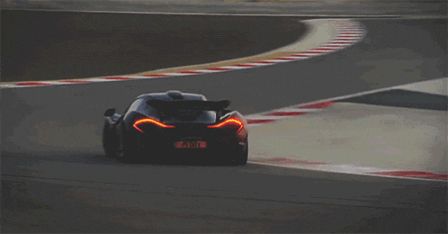 a black sports car with a license plate that says ' gt7 ' on it is driving on a race track