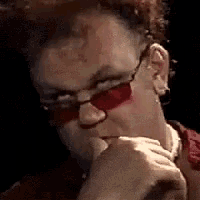 a man wearing red sunglasses and a red shirt is thinking .