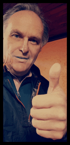 a man is giving a thumbs up sign with his left hand