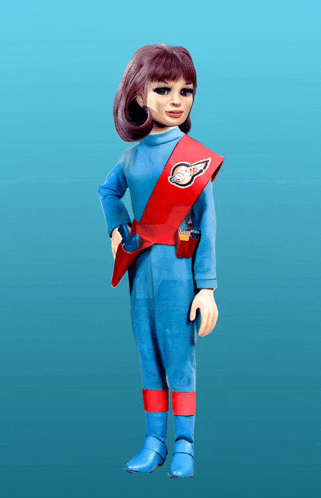 a doll in a blue and red outfit has a badge on her shoulder that says s.p.d.