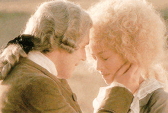 a man and a woman are touching their foreheads