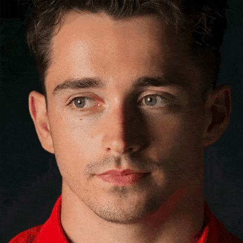 a close up of a man 's face with red eyes