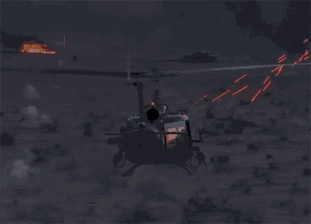 a helicopter is flying through the air at night with smoke coming out of it