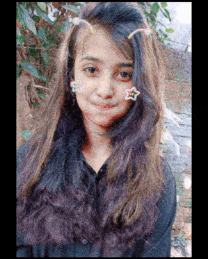 a young girl with a nose ring and stars on her face .