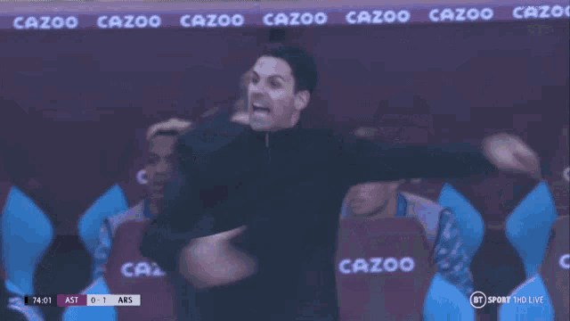 a soccer game is being played in a stadium that has the word cazoo on the wall