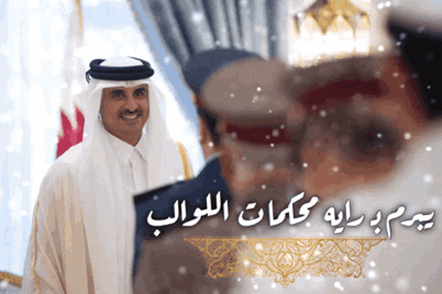 a man in a white robe stands in front of a sign that has arabic writing on it