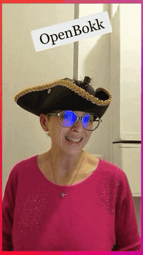 a woman wearing a pirate hat and sunglasses with a sign that says openbokk