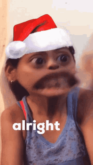 a girl wearing a santa hat has the word alright on her chest