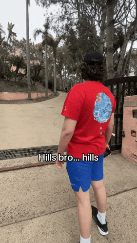 a man wearing a red shirt that says hills bro hills