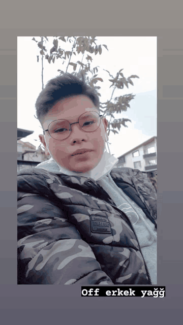 a young man wearing glasses and a camo jacket says off erkek yagg on the bottom