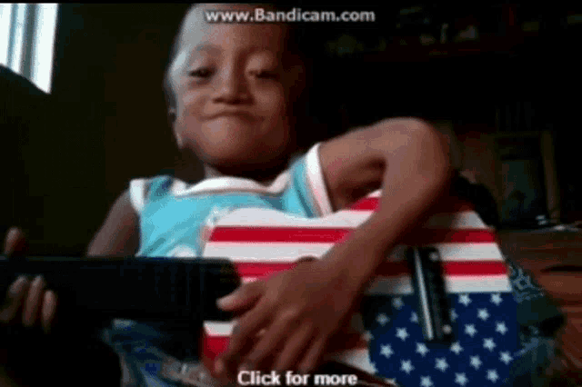 a child is playing a guitar with the words click for more on the bottom of the screen
