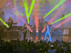 a group of people playing instruments on a stage in front of a sign that says ' a year of ' on it