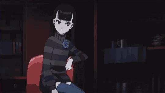 a girl in a striped sweater sits on a chair