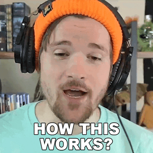 a man wearing headphones and an orange beanie is asking how this works