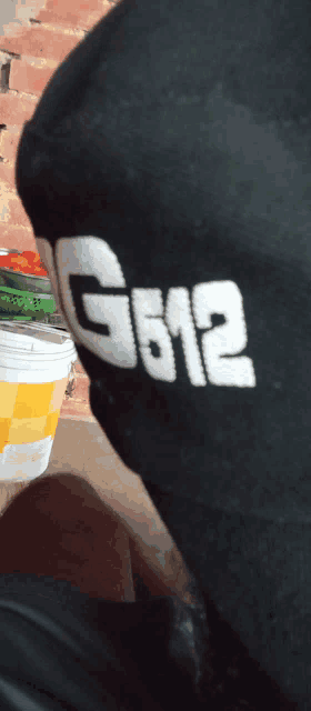 a person wearing a black shirt that says g612 on the sleeve