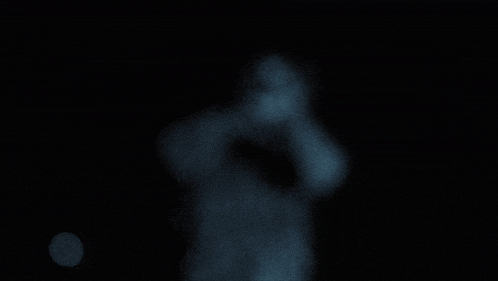 blue smoke is coming out of a hole in a black background