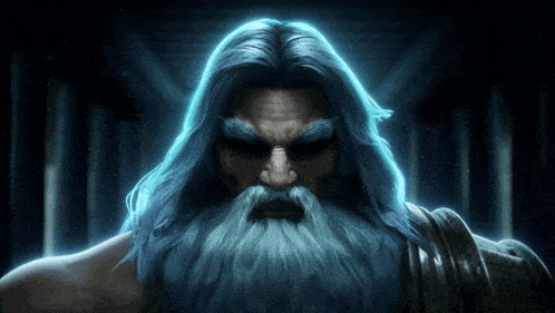 a man with long hair and a beard looks at the camera