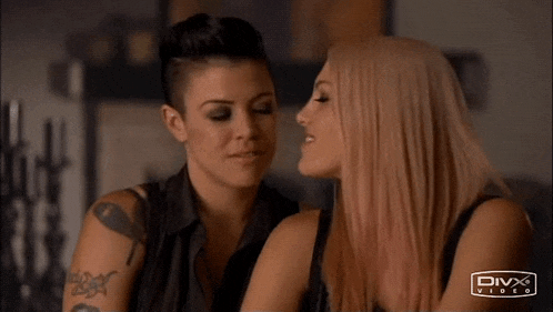 two women are touching each other 's noses in a divx video ad