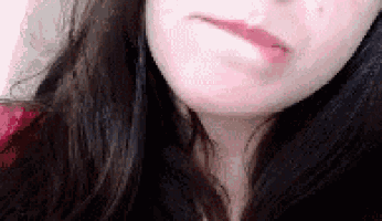 a close up of a woman 's face with a slight smile on her face .