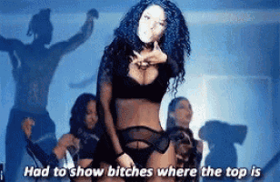 a woman in lingerie is standing in front of a group of dancers and says " had to show bitches where the top is "