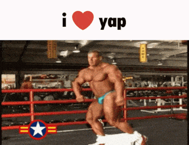 a man in a blue bikini is running in a boxing ring with the words i love yap above him