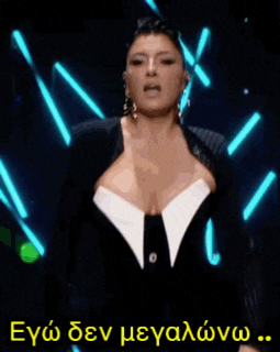 a woman in a black and white dress is screaming in a foreign language .