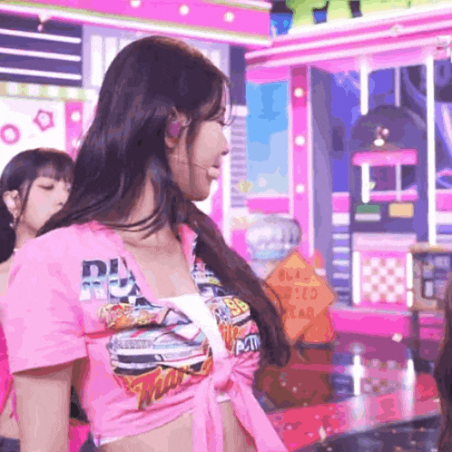 a woman is wearing a pink shirt that says rm on it