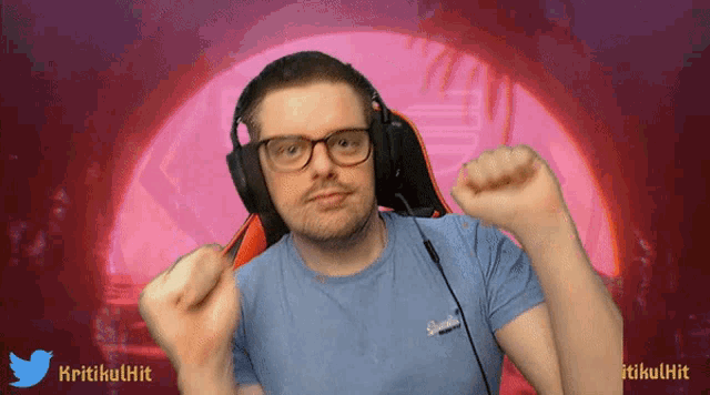a man wearing headphones and a blue shirt with the word kritikulhit on it
